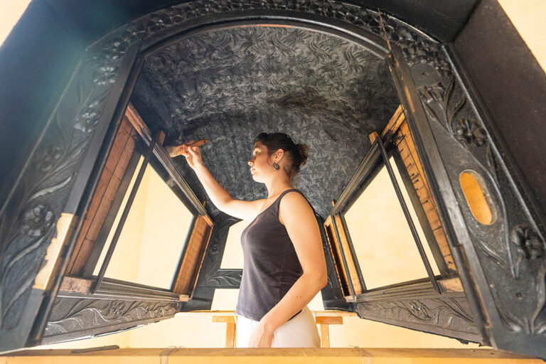 Conservator treats the felze cover from the Laura Gondola in Ca' Rezzonico Museum